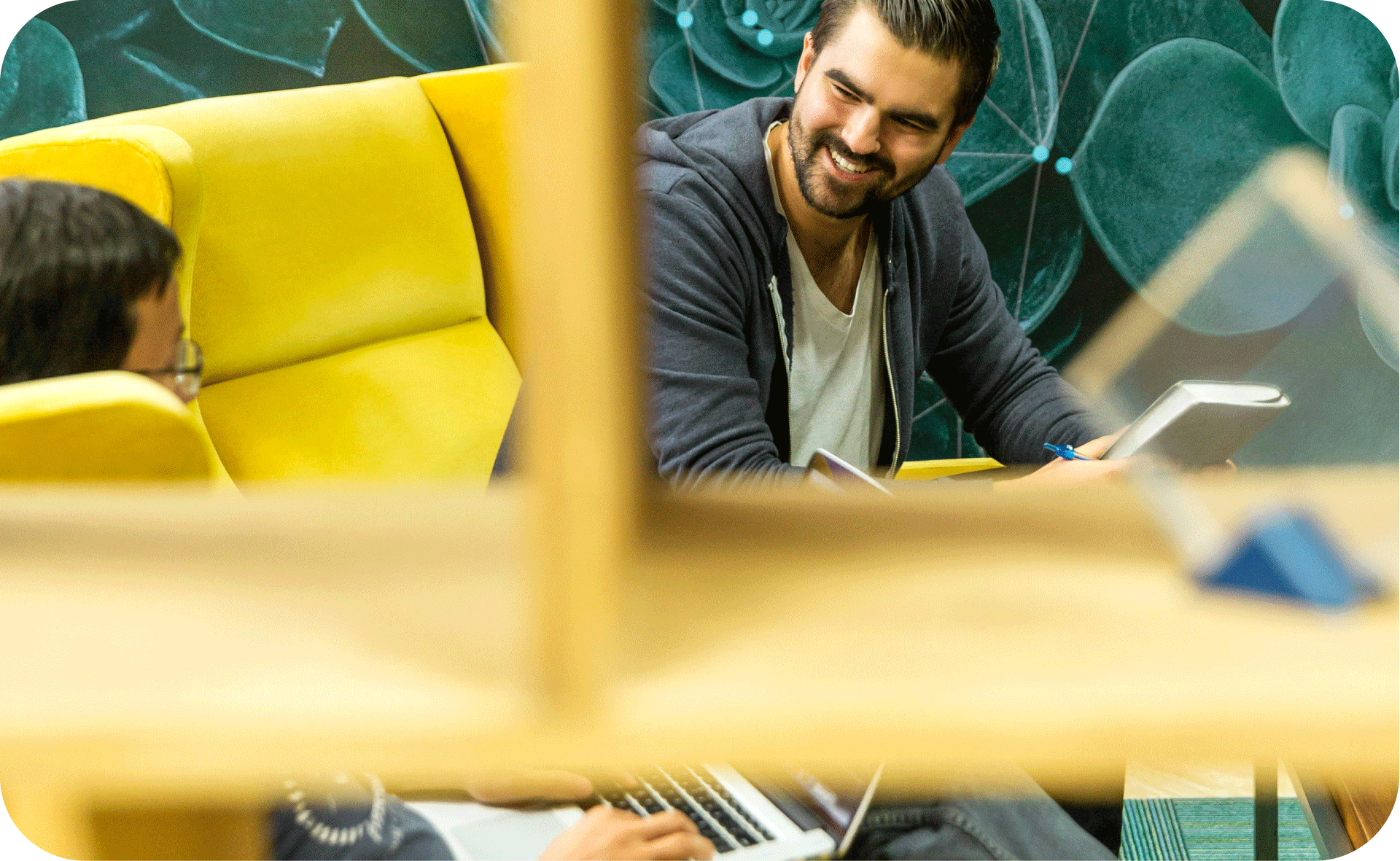 Two teammates collaborating in the workplace with a laptop